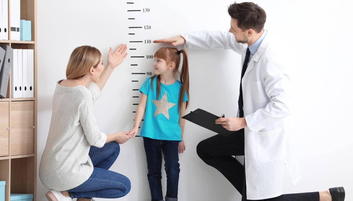 Pediatrician assessing child growth and development at Juniors Children's Clinic in Beeramguda