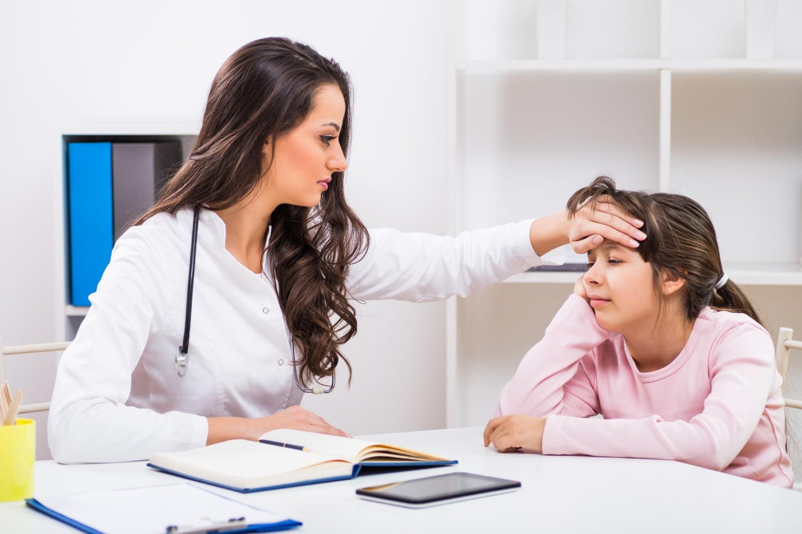 Pediatrician examining a child with fever at Juniors Children's Clinic in Beeramguda